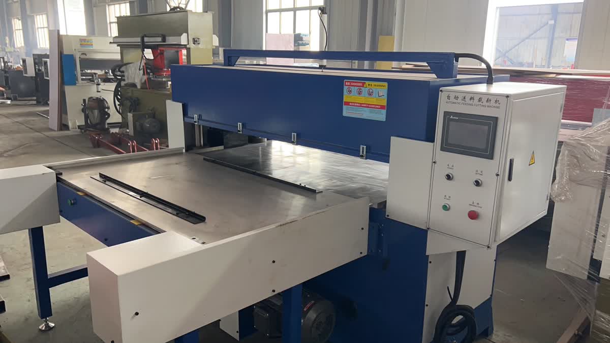 Single-side feeding cutting machine with powered table and control panel