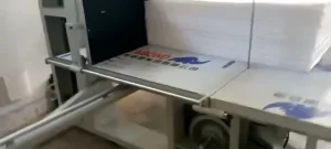 Stacked EPE foam on the worktable of a vertical cutting machine