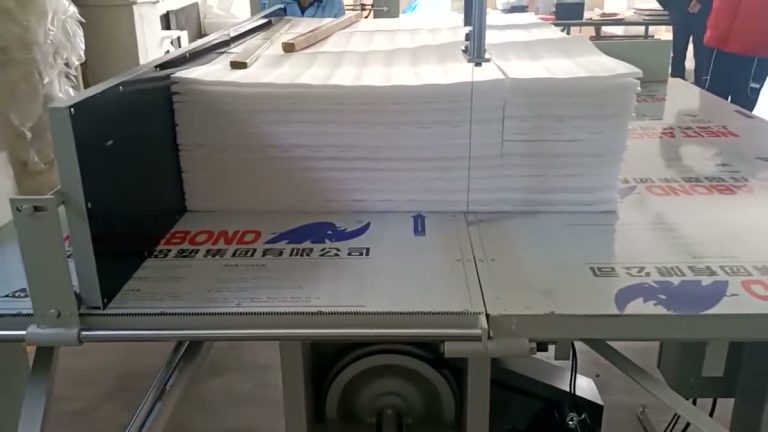 Vertical cutting machine dividing white EPE foam with protective film retained